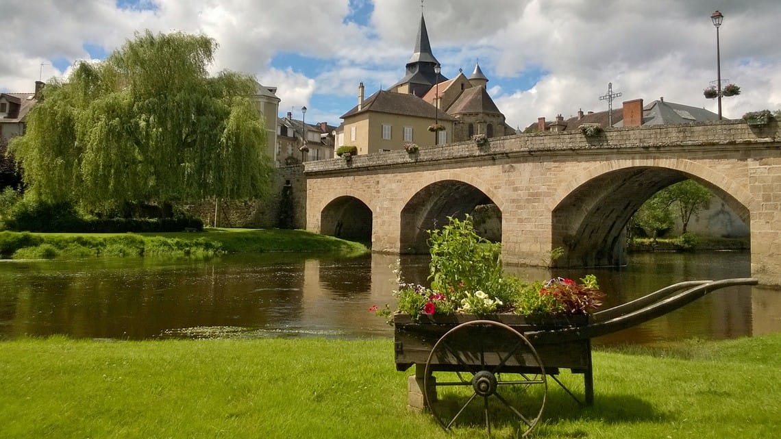 Bridge and flower cart by river